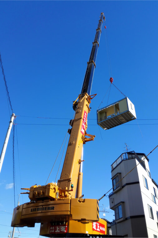 写真：ユニットハウスをクレーンで据付している様子